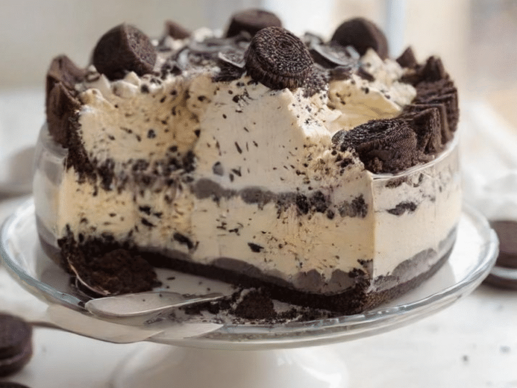 5 Healthy High-Protein Desserts You’ll Love 5 Oreo protein cheesecake with creamy filling and crushed Oreo topping in a glass dish.